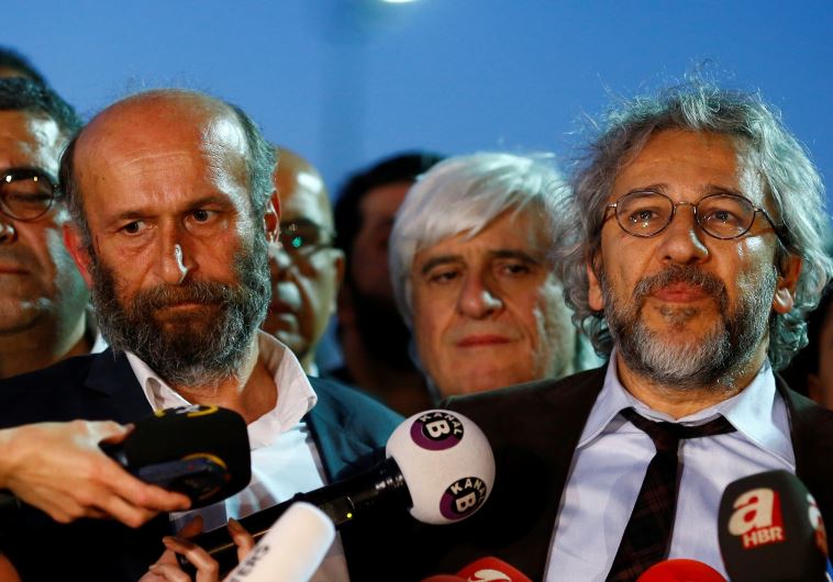 Can Dundar (R), editor-in-chief of Cumhuriyet, accompanied by his Ankara bureau chief Erdem Gul