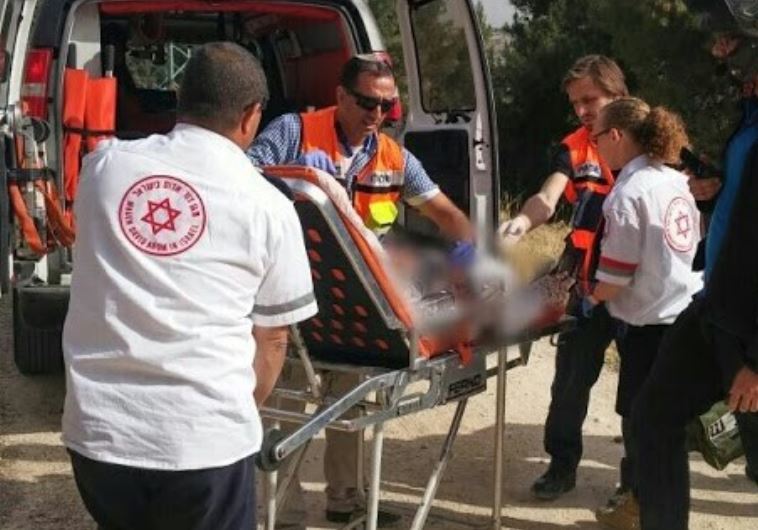 MDA paramedics treat victim at scene of suspected terror stabbing in Jerusalem's Armon Hanatziv