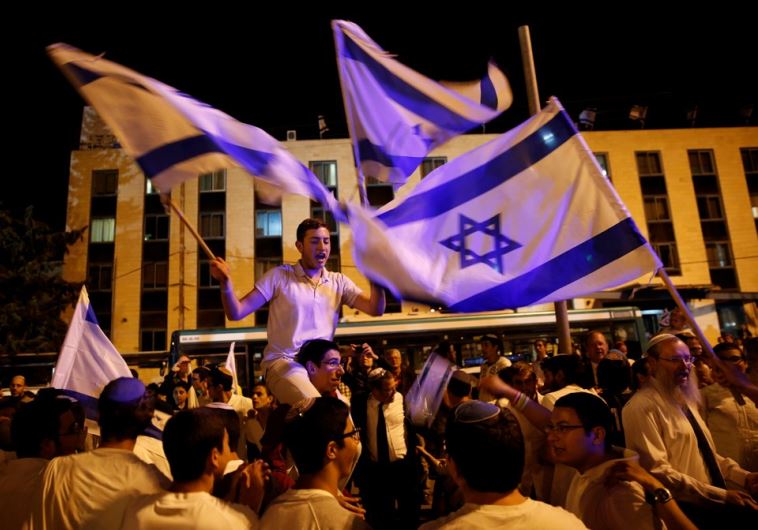 Israelis dance with Israeli national flags during celebrations marking Israel's 68th Independence Day in Jerusalem