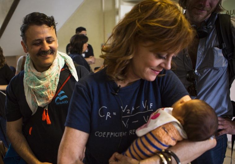 Actress Susan Sarandon holds a refugee baby at Rathaus Wilmersdorf refugee shelter in Berlin