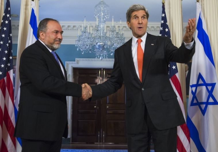 US Secretary of State John Kerry (R) and then-foreign minister Avigdor Liberman shake hands in Washington