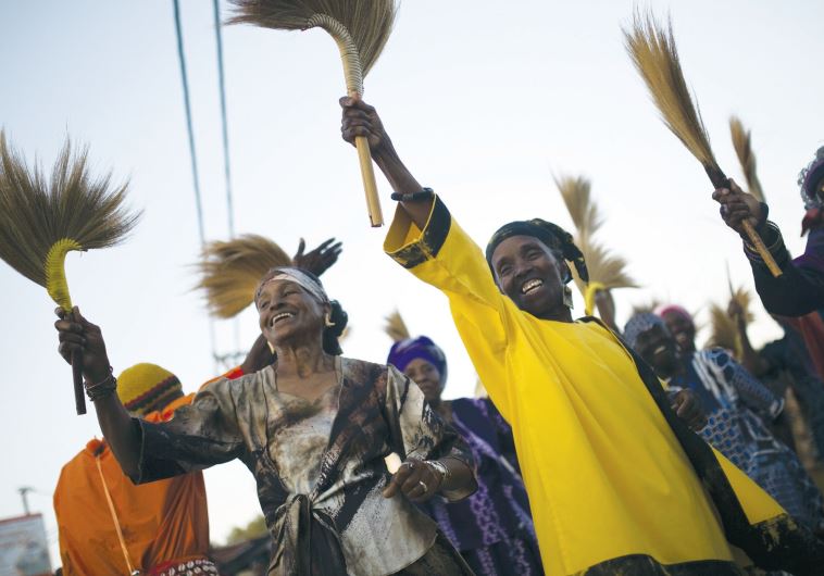 Members of the Black Hebrews dance as they take part in celebrations for Shavuot in Dimona