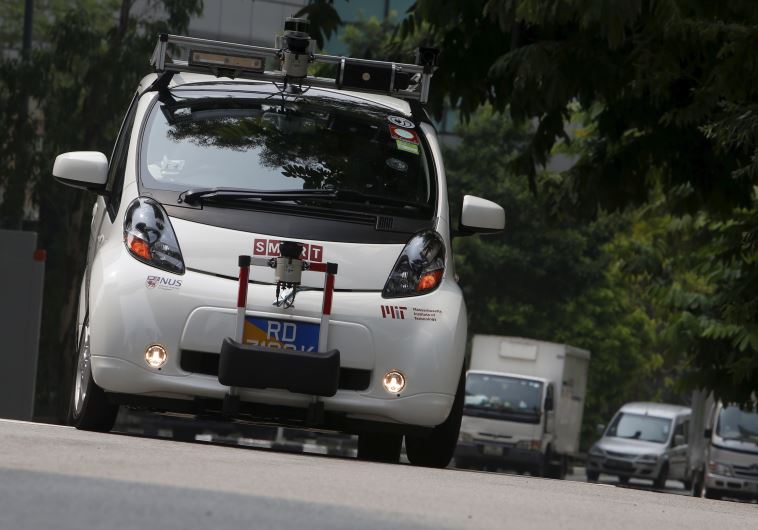 An autonomous self-driving vehicle goes onto the road during a demonstration at one-north business park in Singapore October 12, 2015.