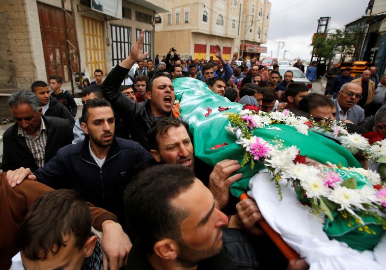 Palestinians hold the funeral for a man shot dead by Israeli forces after an attack on a soldier on March 24 in the West Bank city of Hebron