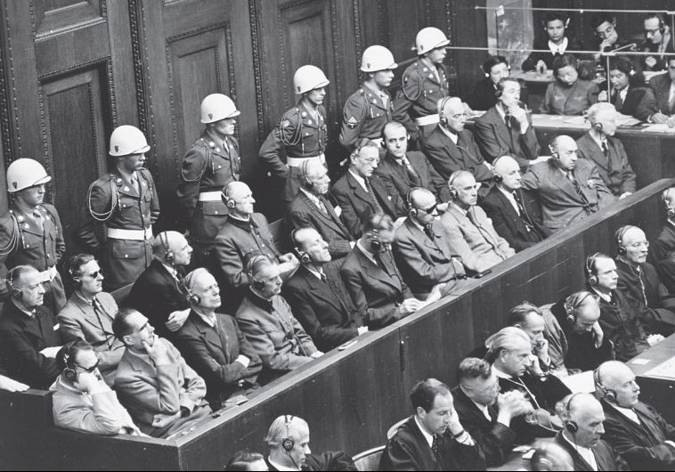 Nazi defendants listen to testimony at the Nuremberg trials, which set a precedent for prosecuting crimes against humanity