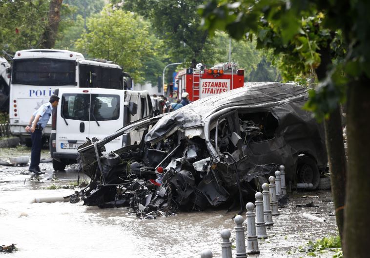A destroyed van is pictured near a Turkish police bus which was targeted in a bomb attack in a central Istanbul district, Turkey, June 7, 2016. 