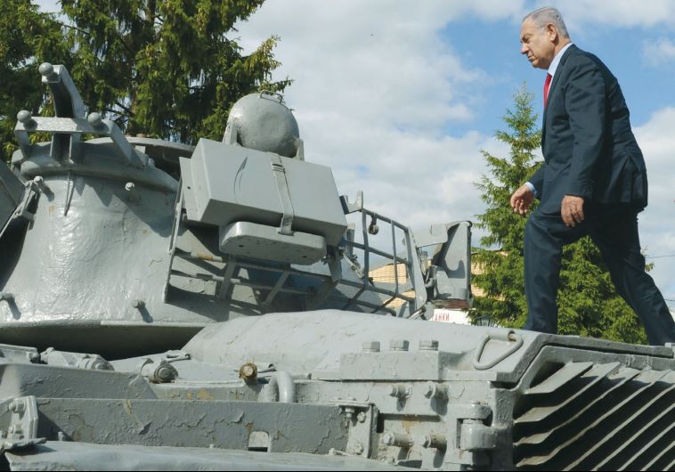 PRIME MINISTER Benjamin Netanyahu walks atop an Israeli tank that had been lost during the First Lebanon War, in Moscow yesterday.