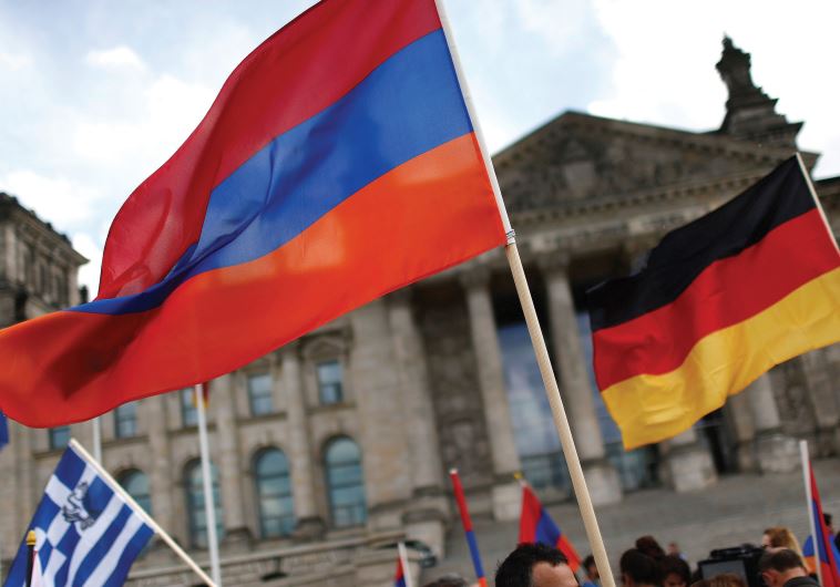 SUPPORTERS WAVE Armenian and German flags earlier this month in front of the Reichstag, as they protest in favor of the resolution that declares the 1915 massacre of Armenians by Ottoman forces a ‘genocide