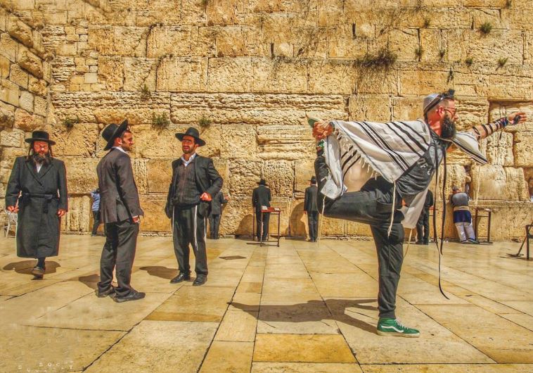 AMERICAN YOGA master Seth Kaufman doing yoga at the Western Wall in Jerusalem.