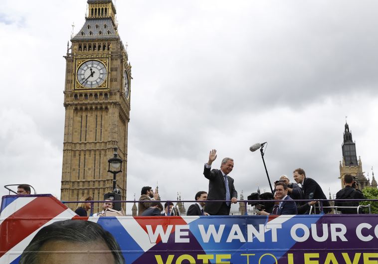 Leader of the United Kingdom Independence Party (UKIP) Nigel Farage waves a launch for an EU referendum poster from a bus at Parliament Square in London, Britain June 16, 2016.