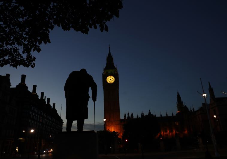 Dawn breaks behind the Houses of Parliament and the statue of Winston Churchill in Westminster, London, Britain June 24, 2016