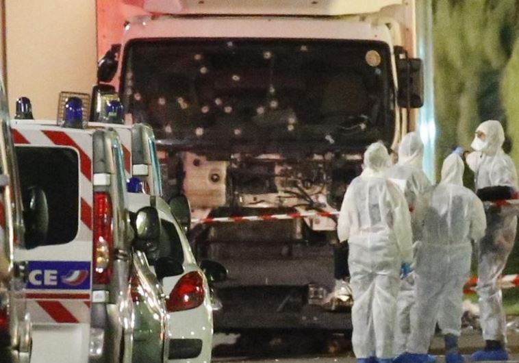 French police forces and forensic officers stand next to a truck July 15, 2016 that ran into a crowd celebrating the Bastille Day national holiday on the Promenade des Anglais killing at least 60 people in Nice, France, July 14. 