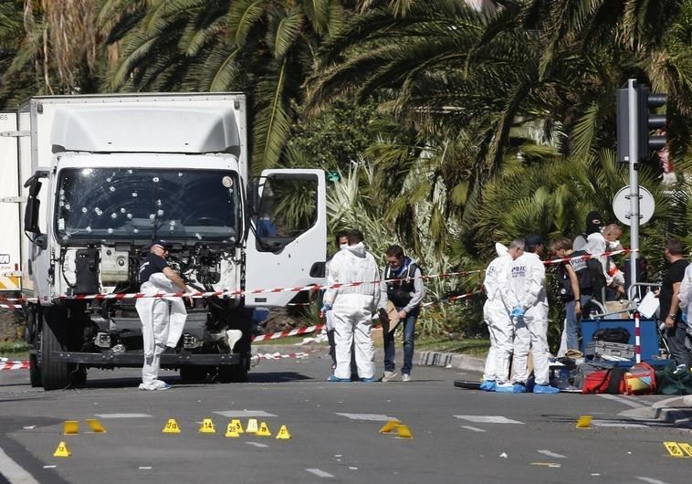 Investigators continue at the scene near the heavy truck that ran into a crowd at high speed killing scores who were celebrating the Bastille Day July 14 national holiday on the Promenade des Anglais in Nice, France, July 15, 2016. 