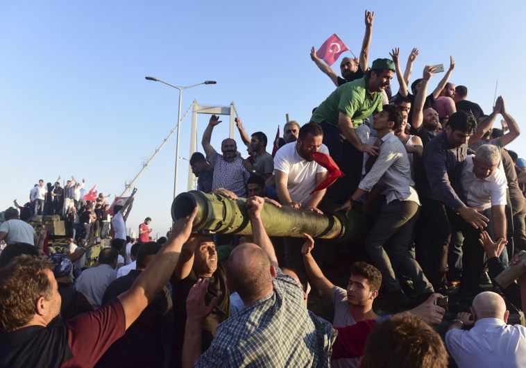 Supporters of Tukish President Tayyip Erdogan celebrate after soldiers involved in the coup surrendered on the Bosphorus Bridge in Istanbul, Turkey July 16, 2016.