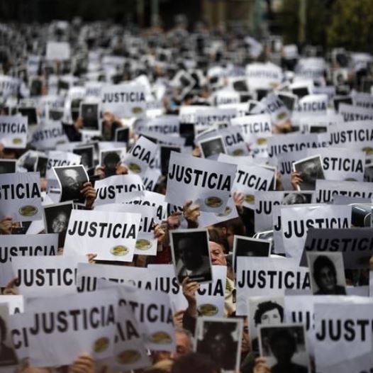 DATE IMPORTED: July 18, 2013 Thousands of people hold up signs reading, "Justice" as they gather to commemorate the 19th anniversary of the 1994 bombing of the Argentine Israeli Mutual Association (AMIA) Jewish community center in Buenos Aires July 18, 2013.