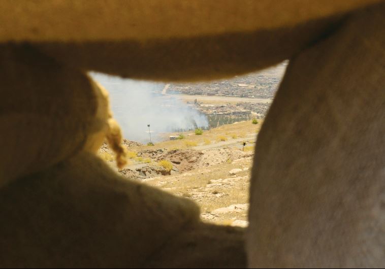 An explotion is seen on territory controlled by Islamic State, fired by Kurdish Peshmerga fighters in Bashiq