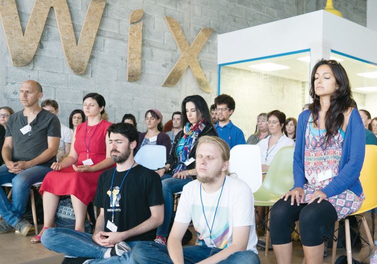 A group meditates during a mindfulness exercise
