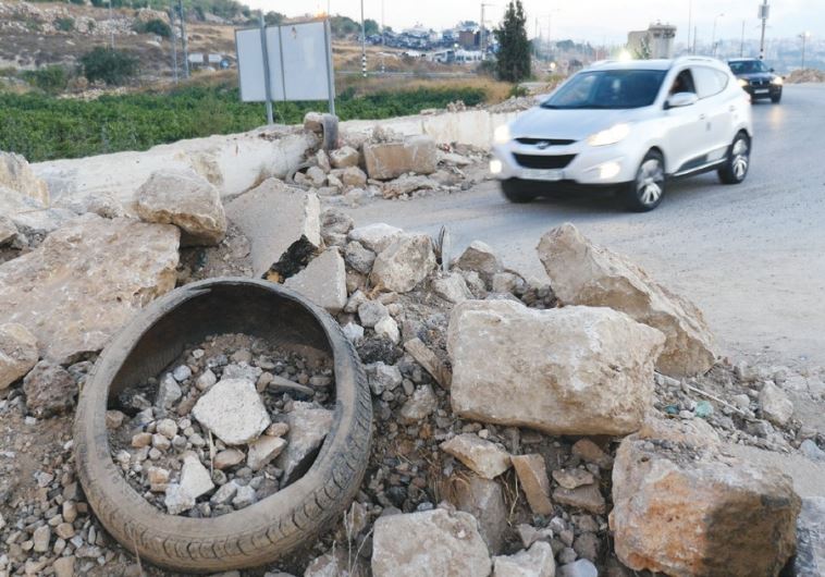 A MOUND OF EARTH is piled up to serve as a roadblock outside Sa’ir village yesterday. (