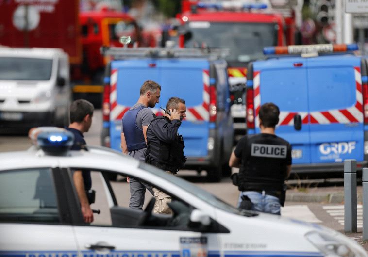 French police officers and firemen arrive at the scene of a hostage-taking at a church in Saint-Etienne-du-Rouvray, northern France, on July 26, 2016