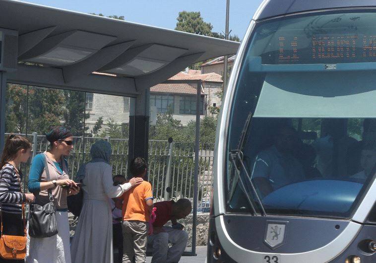 A LIGHT RAIL TRAIN waits at a station in Jerusalem.