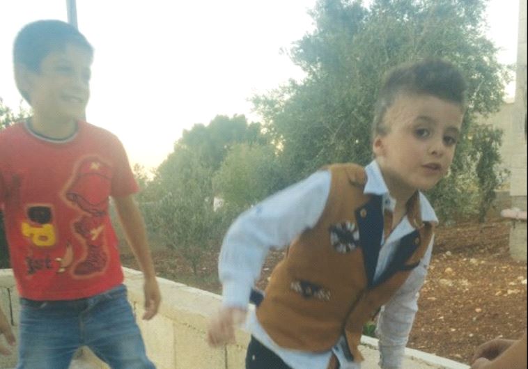 FIREBOMBING SURVIVOR Ahmad Dawabsha plays with his cousins outside their Duma home, July 2016