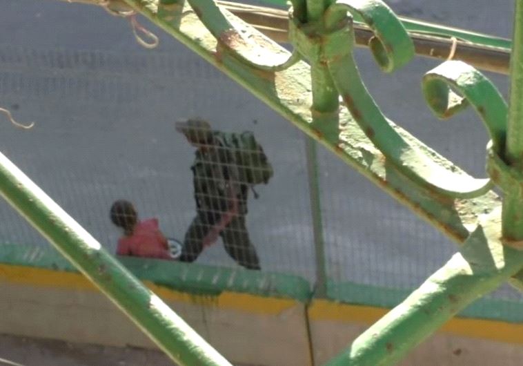 Screenshot of B'tselem video in which Border Policeman seen confiscating Palestinian girl's bike