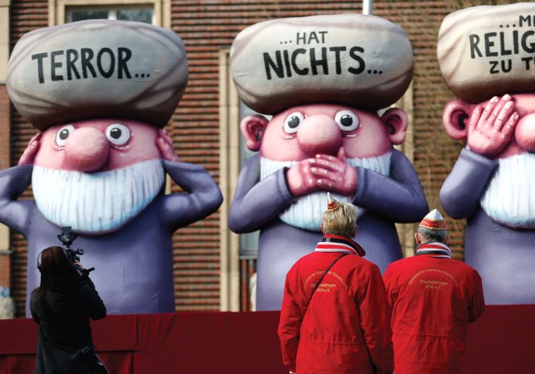 THIS FLOAT at a German parade has the words ‘Terror has nothing to do with religion’ written on three mullahs (monkeys). (