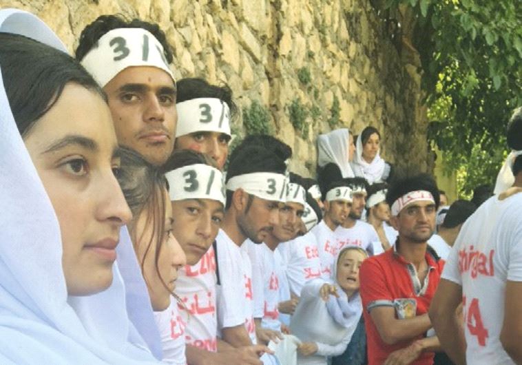 YAZIDI YOUTH demonstrate recently for the recognition of genocide by ISIS at the Lalish Temple in northern Iraq.