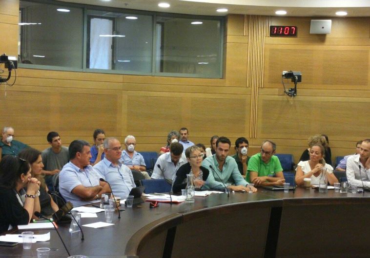 Protestors from Greenpeace Israel storm through a Knesset meeting.