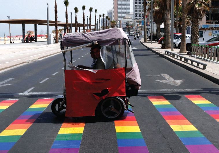 A SIDEWALK painted with colors for the gay pride parade in Tel Aviv. The author wonders why anti-Israel Jewish academics don’t support Israel’s gay rights and liberal values?
