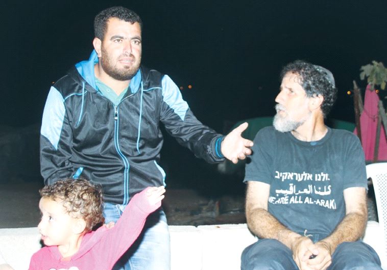 VILLAGER NASSER NAWAJAA makes a point to human rights activist Rabbi Arik Ascherman in Sussiya yesterday.