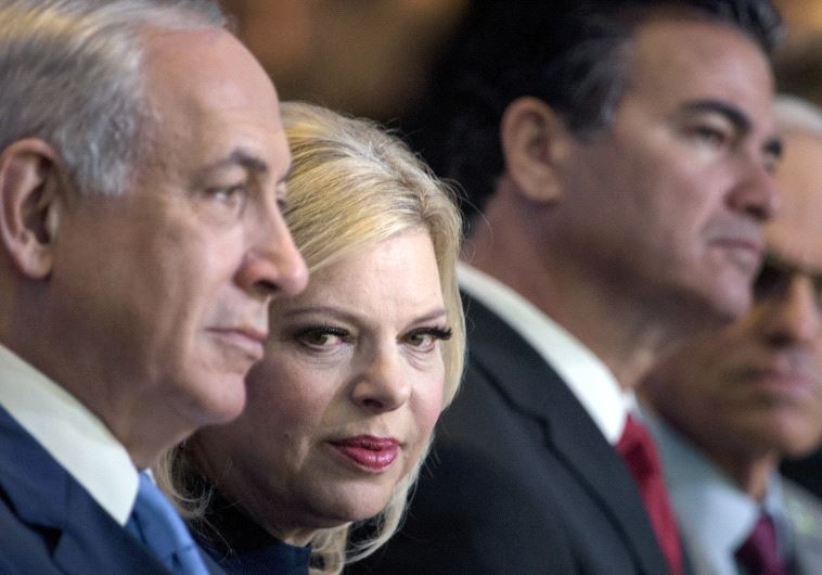 Sara Netanyahu sitting next to Prime Minister Benjamin Netanyahu 