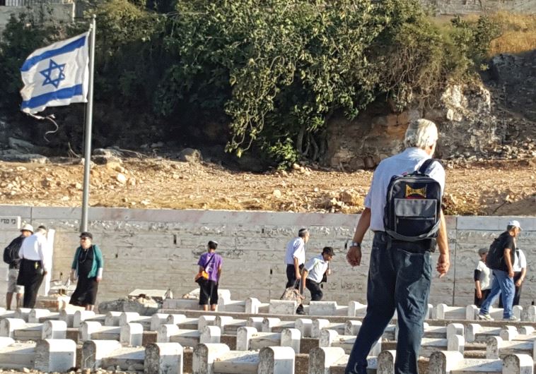 Reciting the Kaddish prayer at the city’s ancient Jewish cemetery