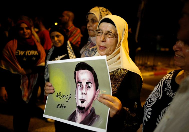 The mother of the hunger-striking Palestinian prisoner Bilal Kayed holds his picture during a protest in favour of his release, at Barzilai Hospital in the southern Israeli city of Ashkelon August 9, 2016