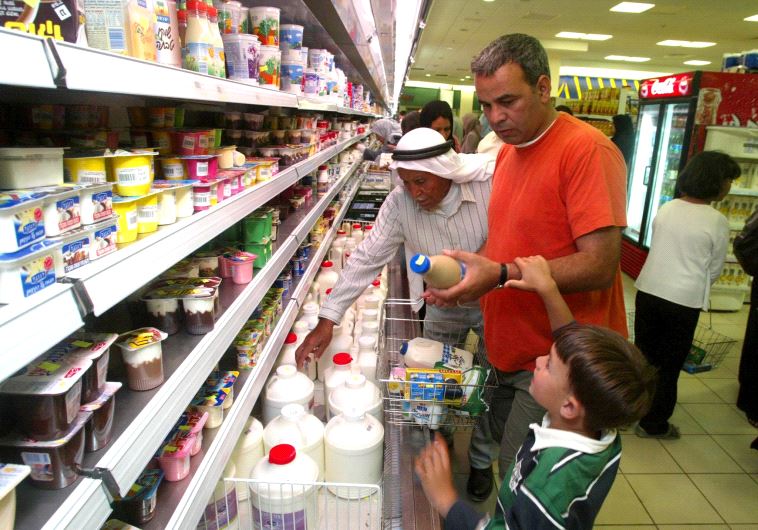 Shoppers buy Israeli food products at a Ramallah supermarket in 2003