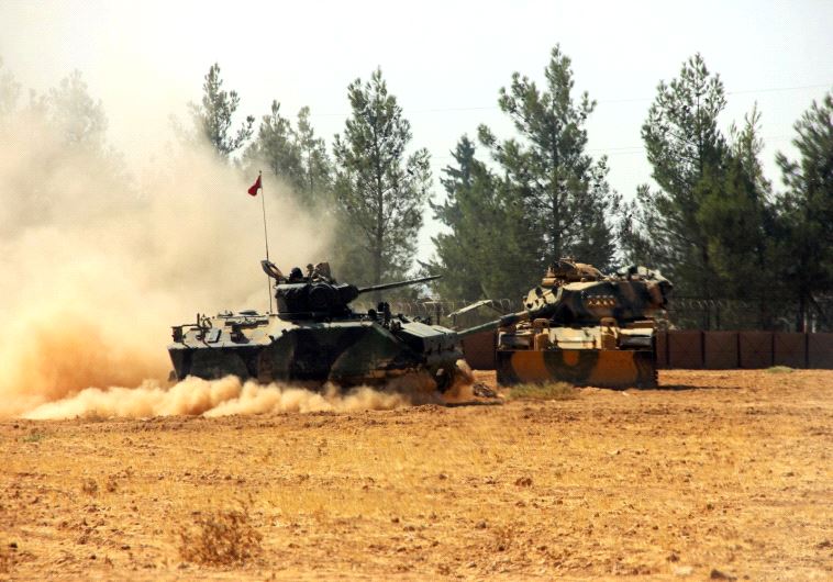 A Turkish army tank and an armoured vehicle are stationed near the Turkish-Syrian border in Karkamis in the southeastern Gaziantep province, Turkey, August 23, 2016