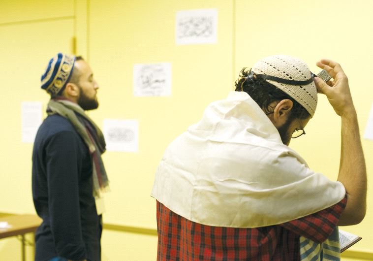 Muslim and Jewish participants in the seventh annual Muslim Jewish Conference perform Friday prayers