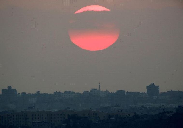 The sun sets over the northern Gaza Strip as seen from the Israeli border, Israel August 23, 2016