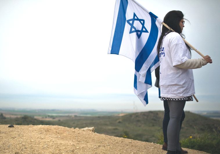 A woman holding an Israeli flag