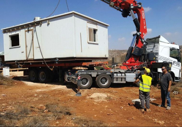AN IDF CRANE yesterday removes the illegally placed modular home belonging to a soldier at the Esh Kodesh outpost in the West Bank.