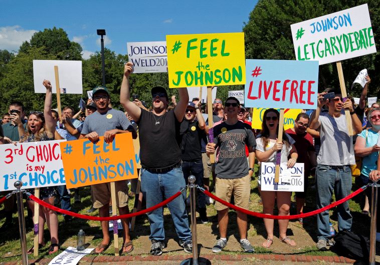 Supporters cheer at a campaign rally with Libertarian presidential candidate Gary Johnson and vice presidential candidate Bill Weld.