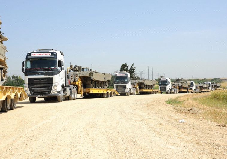 IDF TRANSPORT CENTER’S newly acquired Volvo 600 tank transporters are seen in action on a gravel road.