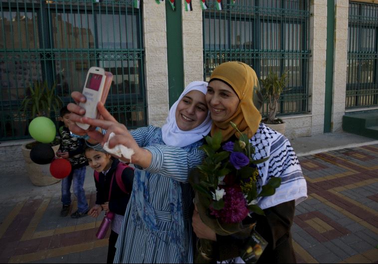 A Palestinian student takes a selfie with teacher Hanan Al Hroub, who is shortlisted to win the Global Teacher Prize, in the West Bank city of Ramallah February 17, 2016. 