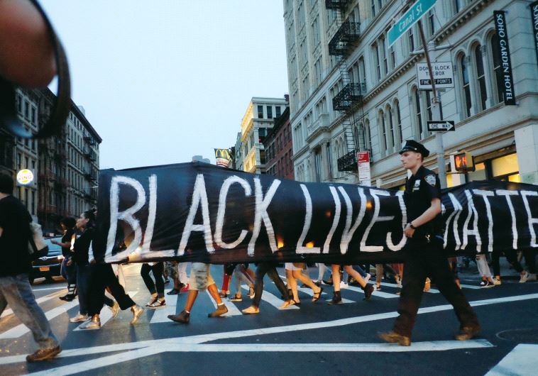 People take part in a protest against police brutality and in support of Black Lives Matter during a march in New York