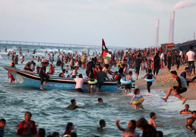 Palestinians swim in the Mediterranean Sea as they enjoy the warm weather in the northern Gaza Strip, August 14, 2015