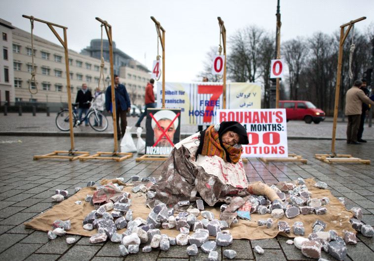 Exiled Iranians protest against executions and stonings in Iran during a demonstration on December 10, 2013 in Berlin