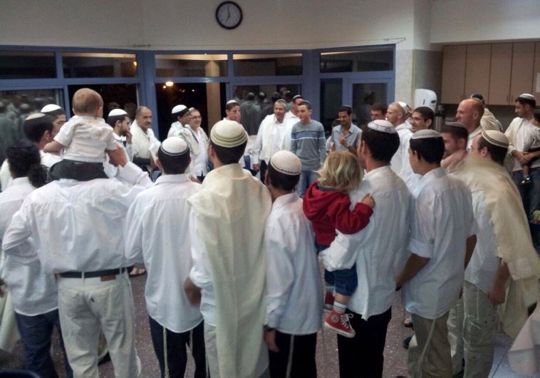 Kibbutznikim and religious volunteers dance and celebrate at the end of Yom Kippur at Kibbutz Ortal last year