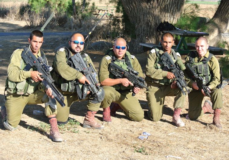 SOLDIERS FROM the Desert Reconnaissance Battalion pose for a group portrait on October 3. They include Muhammad Shibli (second from left), Hussein Fawaze (center) and Roee Hezi (far right). The unit includes Beduin, Jews, Christians, Druse and Circassians.