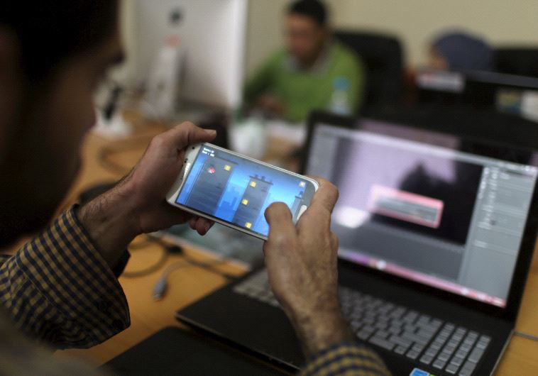 A young Palestinian entrepreneur displays on his mobile a game that he developed at Gaza Sky Geeks office, in Gaza City January 18, 2016.