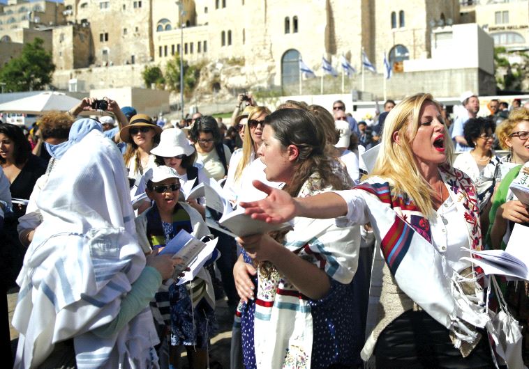 Members of the “Women of the Wall” wear Jewish prayer shawls which the Orthodox Jewish community traditionally reserves for men, during Passover near the Western Wall last April